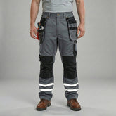 Front View of model wearing B114 100% cotton work pants with hanging tool pockets and reflective stripes, showing removable knee pads